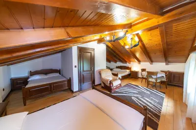 a bedroom with a bed and a dining room at Blake's Villa in Budva