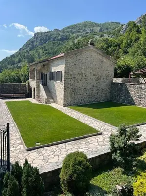 a house with a large yard with green grass at Blake's Villa in Budva