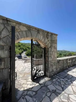 an entrance to a stone building with an iron gate at Blake's Villa in Budva