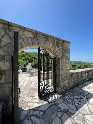 an entrance to a stone building with an iron gate at Blake's Villa in Budva