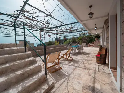 a patio with stairs and a glass roof at Casa Pastrovici del Mare in Petrovac na Moru