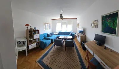 a living room with a blue couch and a table at Appartment Belavista in Bar