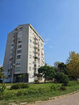 a tall apartment building with a grassy area in front of it at Appartment Belavista in Bar