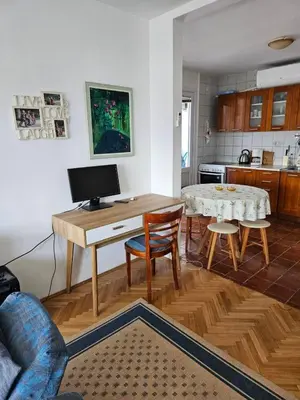 a kitchen with a desk and a table with chairs at Appartment Belavista in Bar