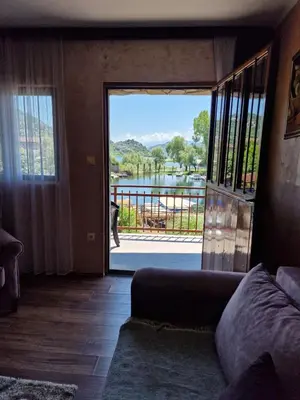 a living room with a door open to a balcony at Lakeside oasis home Karuc in Karuč