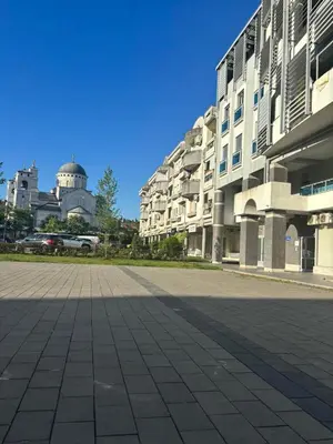 an empty street in front of a building at smgold lux apartman in Podgorica