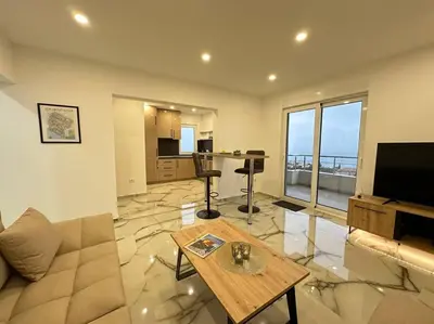a living room with a couch and a table at sunsetmontenegro in Utjeha