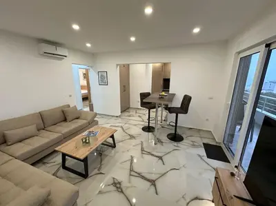 a living room with a couch and a table at sunsetmontenegro in Utjeha