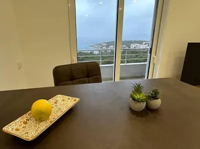 a table with a plate with a lemon and plants on it at sunsetmontenegro in Utjeha