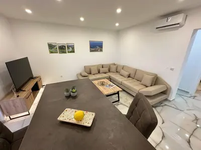 a living room with a table and a couch at sunsetmontenegro in Utjeha