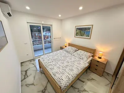 a small bedroom with a bed and a window at sunsetmontenegro in Utjeha