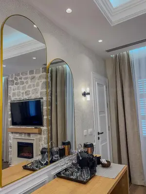 a living room with a mirror and a fireplace at Hive Luxury Suites by MN Property in Kotor
