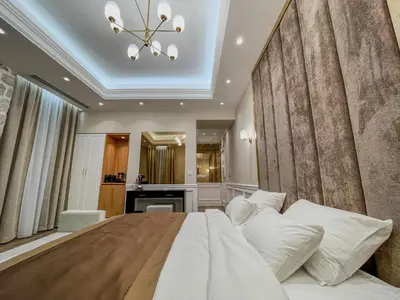 a bedroom with a large bed and a bathroom at Hive Luxury Suites by MN Property in Kotor