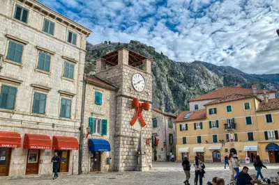 a clock tower on the side of a building at Hive Luxury Suites by MN Property in Kotor