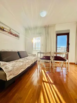 a bedroom with a bed and a table and chairs at SeaScape in Bar