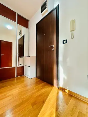 an empty room with a wooden door and wooden floors at SeaScape in Bar