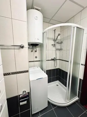 a small bathroom with a shower and a sink at SeaScape in Bar