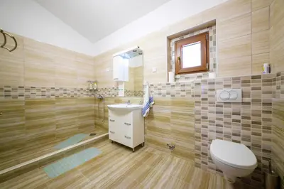 a bathroom with a toilet and a sink at Apartmani Popović in Popovići
