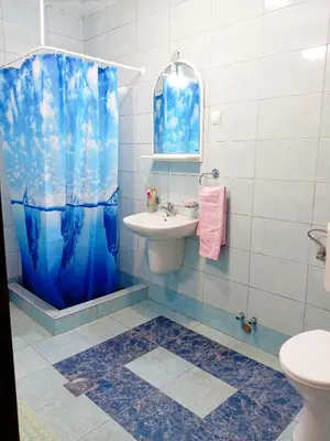 a bathroom with a sink and a shower curtain at Apartmani Popović in Popovići