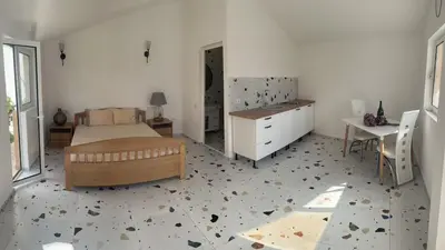 a bedroom with a bed and a table and a desk at La Terrazza in Dobra Voda