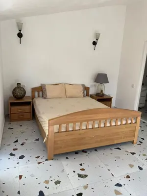 a bedroom with a wooden bed and two night stands at La Terrazza in Dobra Voda