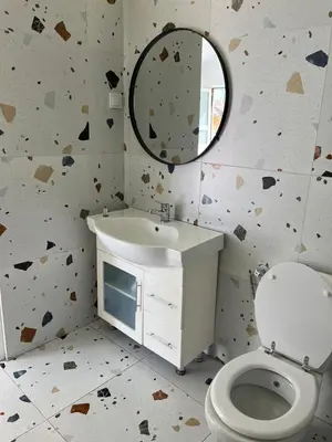 a bathroom with a toilet and a sink and a mirror at La Terrazza in Dobra Voda