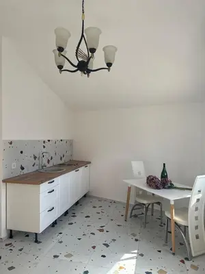 a kitchen with a table and a white counter and a table at La Terrazza in Dobra Voda