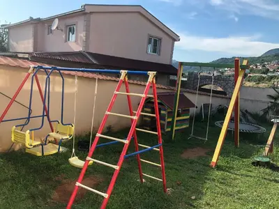 a group of playground equipment in front of a house at La Terrazza in Dobra Voda