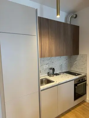 a kitchen with a sink and a refrigerator at Cozy sea view apt with garage in Budva