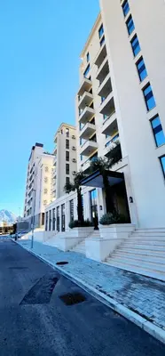 a building with stairs in front of a street at MM Apartment in Budva