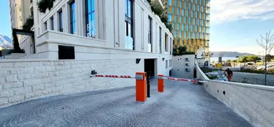 a building with orange posts on the side of a street at MM Apartment in Budva