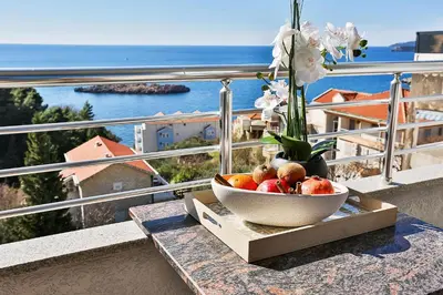 a bowl of fruit on a table on a balcony at Villa Vanty in Sveti Stefan
