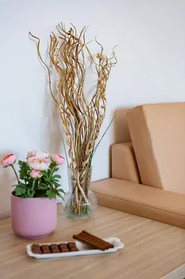 a table with a vase of flowers and a coaster at Villa Vanty in Sveti Stefan