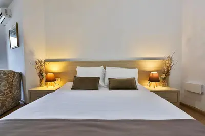 a bedroom with a large white bed with two pillows at Villa Vanty in Sveti Stefan
