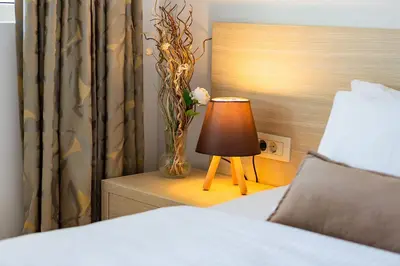 a bedroom with a bed and a table with a lamp at Villa Vanty in Sveti Stefan