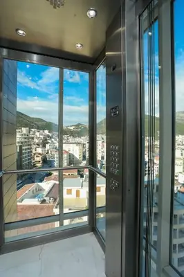 an elevator in a building with a view of a city at Status-M Apartments WOW in Budva