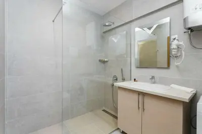 a bathroom with a shower and a sink and a mirror at Status-M Apartments WOW in Budva