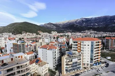 an aerial view of a city with buildings and mountains at Status-M Apartments WOW in Budva