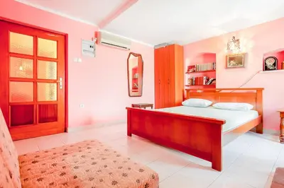a bedroom with a bed and a large window at Apartment More - Konoba More in Pržno