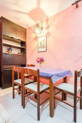 a dining room with a table and chairs at Apartment More - Konoba More in Pržno