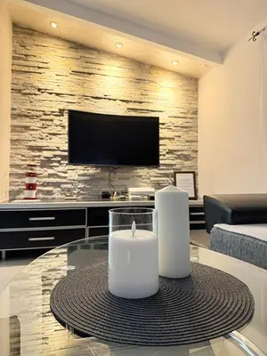 a living room with a table with a candle on it at Anchor 23 in Kotor