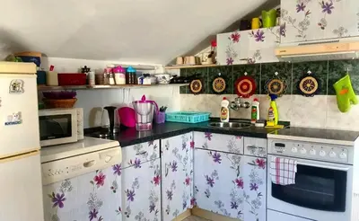 a kitchen with a refrigerator and a stove top oven at SunRoof Apartments in Budva