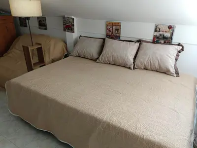 a bedroom with a large bed with two pillows at SunRoof Apartments in Budva