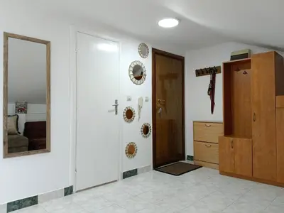 a room with a hallway with a door and a mirror at SunRoof Apartments in Budva