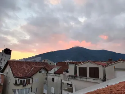 a view of a mountain from a city with houses at SunRoof Apartments in Budva