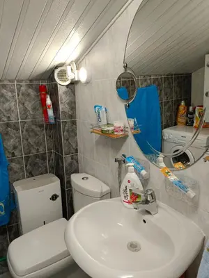 a bathroom with a white sink and a toilet at SunRoof Apartments in Budva