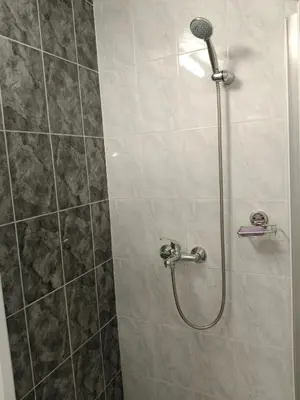a shower with a shower head in a bathroom at SunRoof Apartments in Budva