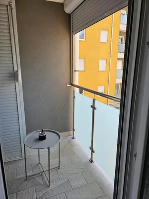 a small table in a room with a window at AGAPE Apartment in Podgorica