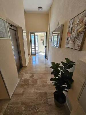 a hallway of a building with a potted plant at AGAPE Apartment in Podgorica