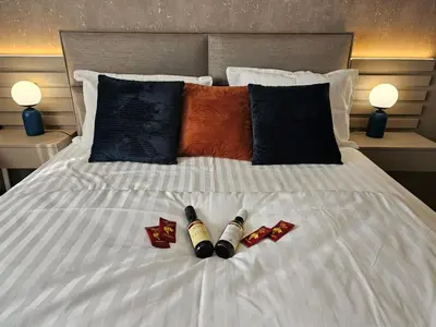 a bed with two crayons on it withhibahibahibahibahibahiba at AGAPE Apartment in Podgorica